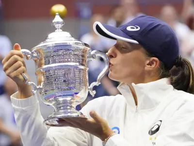 Sep 10, 2022; Flushing, NY, USA; Iga Swiatek (POL) celebrates with the championship trophy after her match against Ons Jabeur (TUN) (not pictured) in the women's singles final on day thirteen of the 2022 U.S. Open tennis tournament at USTA Billie Jean King Tennis Center. Mandatory Credit: Robert Deutsch-USA TODAY Sports