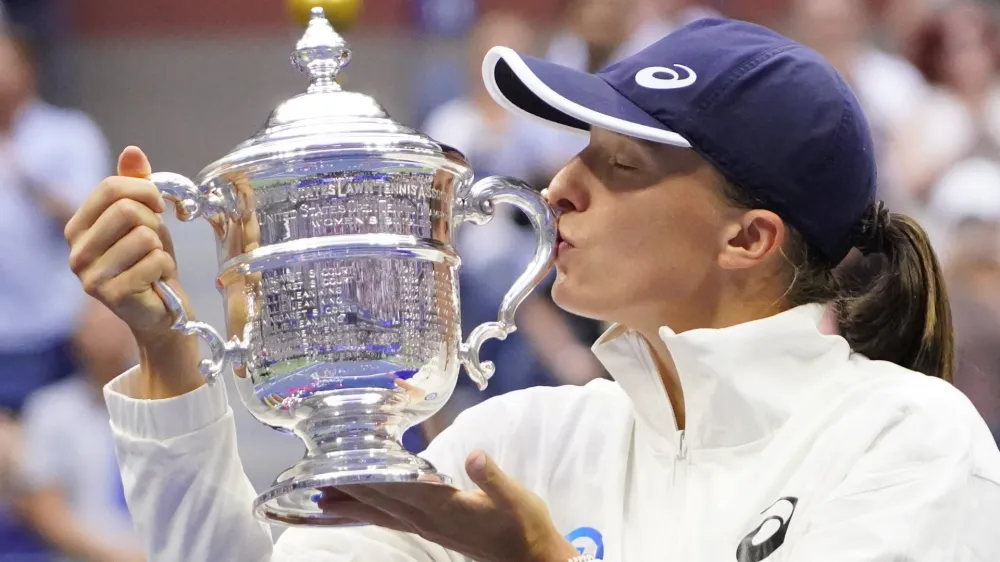 Sep 10, 2022; Flushing, NY, USA; Iga Swiatek (POL) celebrates with the championship trophy after her match against Ons Jabeur (TUN) (not pictured) in the women's singles final on day thirteen of the 2022 U.S. Open tennis tournament at USTA Billie Jean King Tennis Center. Mandatory Credit: Robert Deutsch-USA TODAY Sports