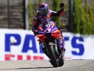 Spain's Jorge Martin waves from his Ducati during a qualifying round at the German Moto Grand Prix, in Hohenstein-Ernstthal, Saturday, July 6, 2024. (Robert Michael/dpa via AP)