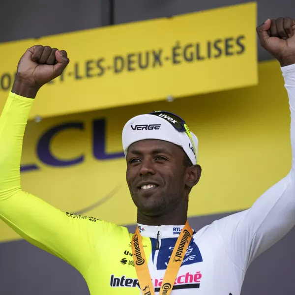 Stage winner Eritrea's Biniam Girmay celebrates on the podium after the eighth stage of the Tour de France cycling race over 183.4 kilometers (114 miles) with start in Semur-en-Auxois and finish in Colombey-les-Deux-Eglises, France, Saturday, July 6, 2024. (AP Photo/Daniel Cole)