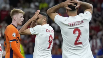 Turkey's Cenk Tosun, center, reacts during a quarterfinal match between the Netherlands and Turkey at the Euro 2024 soccer tournament in Berlin, Germany, Saturday, July 6, 2024. (AP Photo/Ariel Schalit)