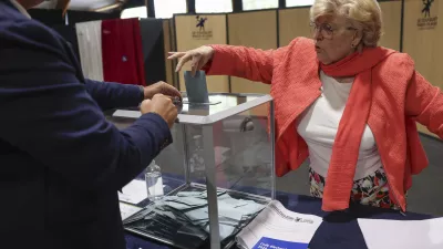 A woman casts her ballot during the second round of the legislative elections in Le Touquet-Paris-Plage, northern France, Sunday July 7 2024. Voting has begun in mainland France on Sunday in pivotal runoff elections that could hand a historic victory to Marine Le Pen's far-right National Rally and its inward-looking, anti-immigrant vision — or produce a hung parliament and political deadlock. (Mohammed Badra, Pool via AP)