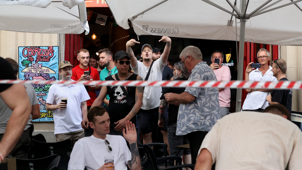  SENSITIVE MATERIAL. THIS IMAGE MAY OFFEND OR DISTURB  A tourist gestures towards demonstrators during a protest against mass tourism in Barcelona, Spain, July 6, 2024. The Catalan capital received more than 12 million tourists in 2023 and expects more in 2024. REUTERS/Bruna Casas