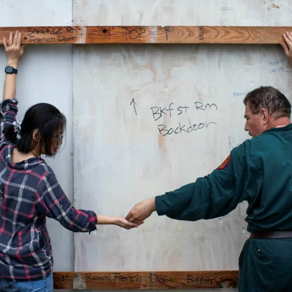 Shan Mei Martinez and Mario Martinez attach door braces to secure their back bay-facing door, as residents prepare for the arrival of Hurricane Beryl in Port Lavaca, Texas, U.S. July 7, 2024. REUTERS/Kaylee Greenlee Beal