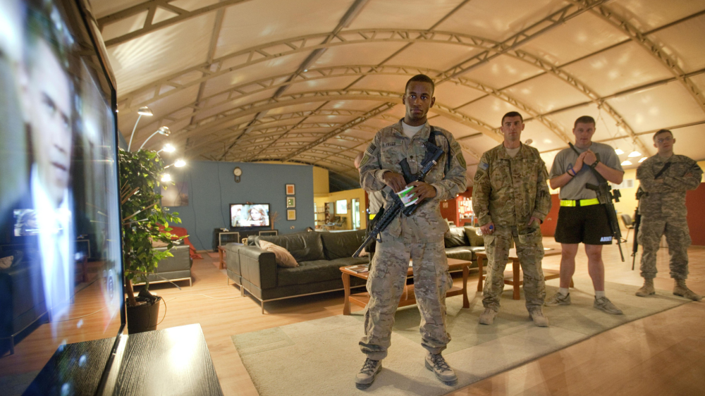 Spc. Gavin Fruge, 22, of Crowley, La., left, watches a rebroadcast of President Barack Obama's speech on proposed troop withdrawal with fellow soldiers at Kandahar Airfield Thursday, June 23, 2011 in Kandahar, Afghanistan. Obama's withdrawal plan for Afghanistan marks the beginning of the end of a troop-intensive approach to countering a Taliban insurgency that until recent months had fought the U.S. and its NATO allies to a standstill. (AP Photo/David Goldman)