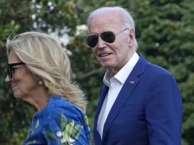 President Joe Biden smiles as he is asked questions by members of the media as he and first lady Jill Biden return on Marine One on the South Lawn of the White House in Washington on Sunday, July 7, 2024, after attending events in Pennsylvania. (AP Photo/Susan Walsh)