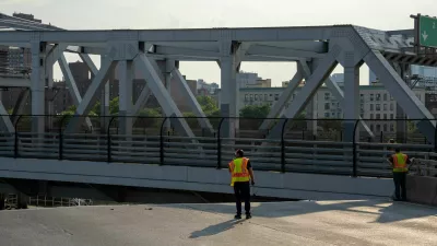 The Fire Department of New York (FDNY) and bridge maintenance workers attempt to cool off the 3rd avenue Bridge after it was stuck in the boat passage position after experiencing overheating, in the Bronx Borough of New York City, U.S., July 8, 2024.REUTERS/David 'Dee' Delgado