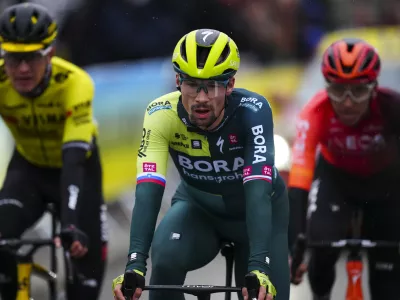 FILE - Slovenia's Primoz Roglic crosses the finish line during the sixth stage of the Paris-Nice cycling race in La Colle-sur-Loup, outside Nice, on March 8, 2024. Tour de France favorites Remco Evenepoel and Primoz Roglic were caught up in a massive crash Thursday June 6, 2024 at the Criterium du Dauphine race that led organizers to neutralize the stage. (AP Photo/Daniel Cole, File)