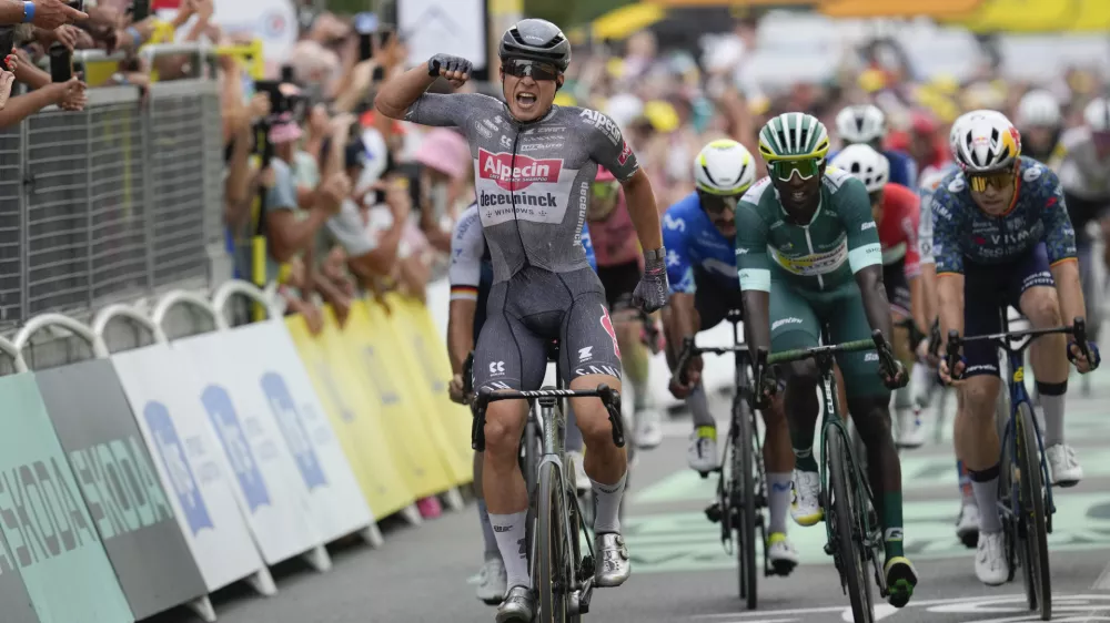 Belgium's Jasper Philipsen celebrates as he crosses the finish line ahead of Germany's Pascal Ackermann, left, Colombia's Fernando Gavira, center in blue, and Eritrea's Biniam Girmay, wearing the best sprinter's green jersey, to win the tenth stage of the Tour de France cycling race over 187.3 kilometers (116.4 miles) with start in Orleans and finish in Saint-Amand-Montrond, France, Tuesday, July 9, 2024. (AP Photo/Jerome Delay)