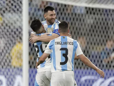 Argentina's Lionel Messi is congratulated after scoring his side's second goal against Canada during a Copa America semifinal soccer match in East Rutherford, N.J., Tuesday, July 9, 2024. (AP Photo/Adam Hunger)