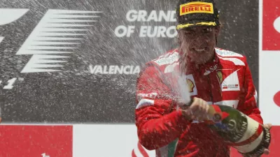 Ferrari Formula One driver Fernando Alonso of Spain sprays champagne during the podium ceremony after the European F1 Grand Prix at the Valencia street circuit June 24, 2012. Alonso won the European Grand Prix on Sunday to become the first repeat winner of the Formula One season after eight races. Finland's Kimi Raikkonen was second for Lotus with seven-times champion Michael Schumacher finishing third for Mercedes in his first appearance on the podium since 2006.  REUTERS/Albert Gea (SPAIN - Tags: SPORT MOTORSPORT)