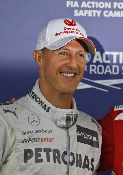 Mercedes Formula 1 car driver Michael Schumacher who finished third following the qualifying session poses for the photographers at the Silverstone circuit, England, Saturday, July 7, 2012. Ferrari Formula 1 car driver Fernando Alonso, of Spain, finished first and will start from the pole position and Red Bull Formula 1 car driver Mark Webber, of Australia finished second. The Formula 1 British Grand Prix will be held at Silverstone circuit on Sunday. (AP Photo/Lefteris Pitarakis)