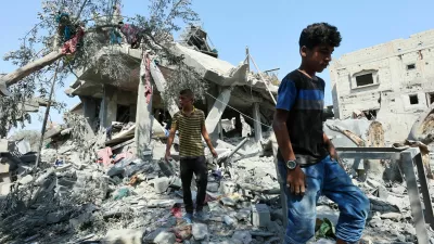 Palestinians inspect a house destroyed in an Israeli strike, amid the Israel-Hamas conflict, in Nusairat refugee camp, in the central Gaza Strip, July 9, 2024. REUTERS/Ramadan Abed