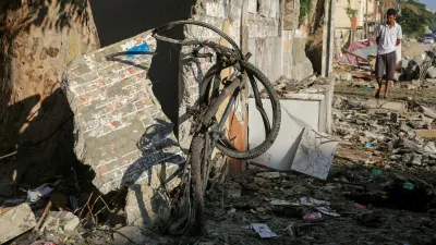 A Palestinian man inspects the site of an Israeli strike, outside a school sheltering displaced people, amid Israel-Hamas conflict, in Khan Younis in the southern Gaza Strip July 10, 2024. REUTERS/Hatem Khaled