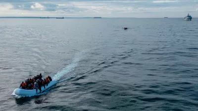 FILE PHOTO: In this drone view two inflatable dinghies carrying migrants pass a French navy vessel as they make their way towards England in the English Channel, Britain, May 4, 2024. REUTERS/Chris J. Ratcliffe/File Photo