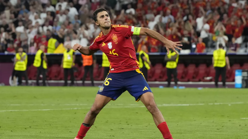 Spain's Rodri celebrates at the end of the semifinal match between Spain and France at the Euro 2024 soccer tournament in Munich, Germany, Tuesday, July 9, 2024. (AP Photo/Hassan Ammar)