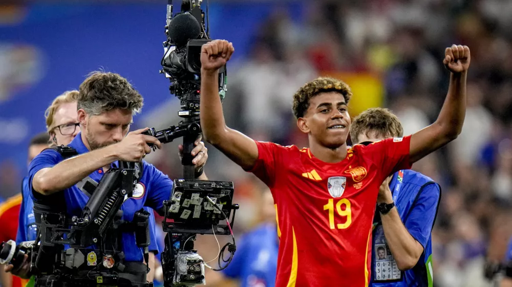 Spain's Lamine Yamal reacts after a semifinal match between Spain and France at the Euro 2024 soccer tournament in Munich, Germany, Tuesday, July 9, 2024. Left Spain's Rodri. (AP Photo/Hassan Ammar)