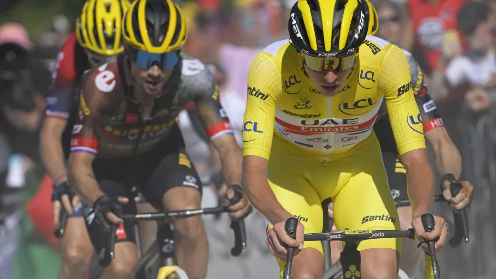 Slovenia's Tadej Pogacar, wearing the overall leader's yellow jersey, and Slovenia's Primoz Roglic climb La Super Planche des Belles Filles,during the seventh stage of the Tour de France cycling race over 176.5 kilometers (109.7 miles) with start Tomblaine and finish in La Super Planche des Belles Filles, France, Friday, July 8, 2022. (Bernard Papon/Pool Photo via AP)