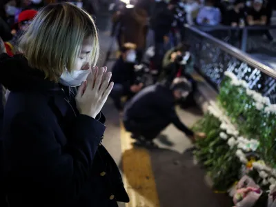 People pay tribute near the scene of the stampede during Halloween festivities, in Seoul, South Korea, October 30, 2022. REUTERS/Kim Hong-ji