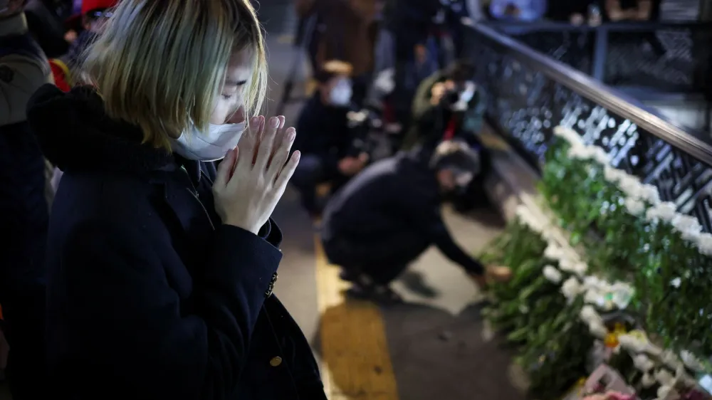 People pay tribute near the scene of the stampede during Halloween festivities, in Seoul, South Korea, October 30, 2022. REUTERS/Kim Hong-ji