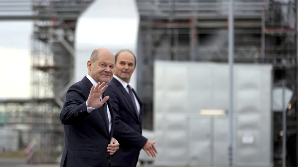 German Chancellor Olaf Scholz, left, is accompanied by the CEO of BASF, Martin Brudermueller, right, as he arrives for a visit of the BASF company in Schwarzheide south of Berlin, Germany, Tuesday, Nov. 1, 2022. (AP Photo/Michael Sohn)