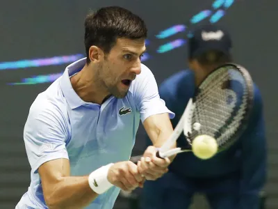 Serbia's Novak Djokovic returns the ball to Stefanos Tsitsipas of Greece during their ATP 500 Astana Open tennis tournament final match in Astana, Kazakhstan, Sunday, Oct. 9, 2022. (AP Photo/Stas Filippov)