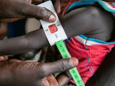 Regina Williams is screened for malnutrition at the Nyong Primary Health Care Unit (PHCU) nutrition site in Torit, where the World Food Programme (WFP) is implementing the blanket supplementary feeding programme (BSFP) nutrition activities, to children, pregnant and lactating women in Torit, within Eastern Equatorial State, of South Sudan, in this photo released November 3, 2022. World Food Programme/Handout via REUTERS THIS IMAGE HAS BEEN SUPPLIED BY A THIRD PARTY. MANDATORY CREDIT.