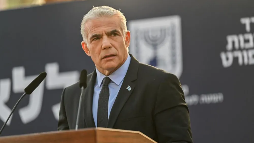 HANDOUT - 06 November 2022, Israel, Jerusalem: Israeli Prime Minister Yair Lapid speaks at the state memorial ceremony for former Prime Minister of Israel Yitzhak Rabin and his wife Leah Rabin at Mt. Herzl. Photo: Kobi Gideon/GPO/dpa - ATTENTION: editorial use only and only if the credit mentioned above is referenced in full