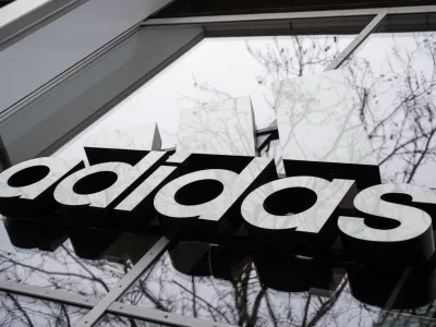 FILED - 12 April 2021, Berlin: The Adidas logo on the facade of a restaurant. The sporting goods and sportswear giant Adidas has again lowered its sales and profit margin forecasts, citing the company's decision to cut ties with controversial US rapper Ye, formerly known as Kanye West. Photo: Christophe Gateau/Deutsche Presse-Agentur GmbH/dpa