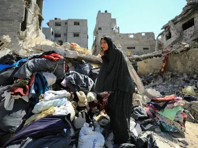 A Palestinian woman inspects the damage, after Israeli forces withdrew from Shejaiya neighborhood, following a ground operation, amid the Israel-Hamas conflict, in the eastern part of Gaza City, July 10, 2024. REUTERS/Dawoud Abu Alkas   TPX IMAGES OF THE DAY