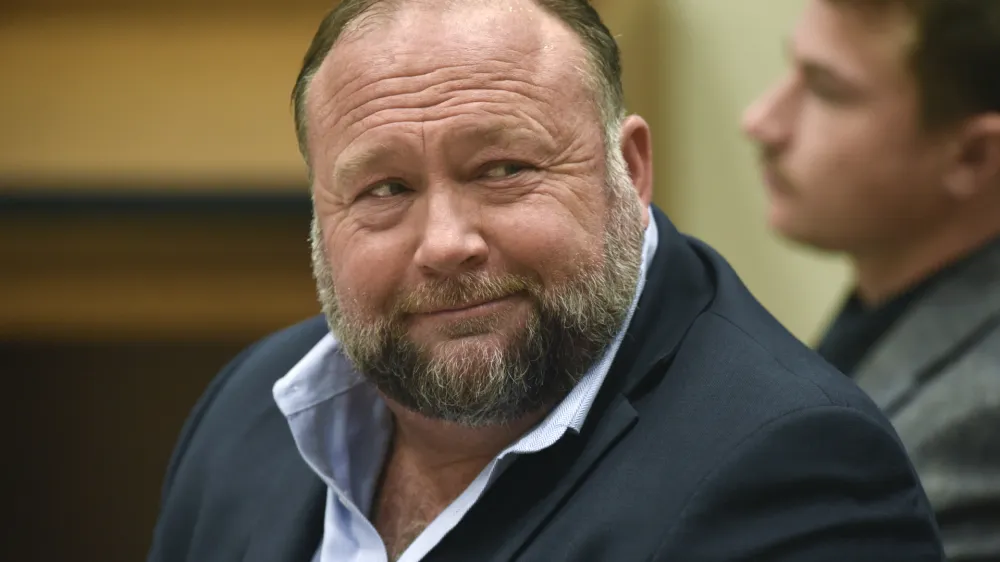 FILE - Infowars founder Alex Jones appears in court to testify during the Sandy Hook defamation damages trial at Connecticut Superior Court in Waterbury, Conn., on Thursday, Sept. 22, 2022. Jones and his company have been ordered to pay an extra $473 million to families and an FBI agent for calling the 2012 Sandy Hook school shooting a hoax. (Tyler Sizemore/Hearst Connecticut Media via AP, Pool, File)