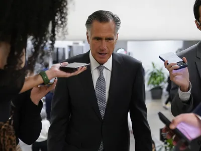 Sen. Mitt Romney, R-Utah, speaks with members of the press before voting on a bill that would enshrine same-sex and interracial marriages into federal law, Wednesday, Nov. 16, 2022, on Capitol Hill in Washington. (AP Photo/Patrick Semansky)