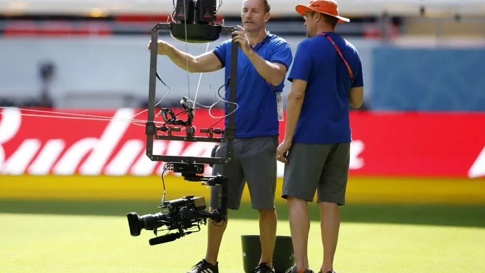 Soccer Football - FIFA World Cup Qatar 2022 - United States team stadium familiarization - Ahmad Bin Ali Stadium, Al Rayyan, Qatar - November 17, 2022 Camera operators work on a spider camera during the United States team stadium familiarization REUTERS/John Sibley