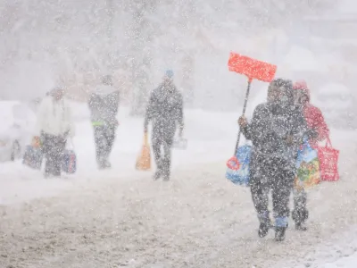 Residents walk on the street during a snowstorm as extreme winter weather hits Buffalo, New York, U.S., November 18, 2022. REUTERS/Lindsay DeDario