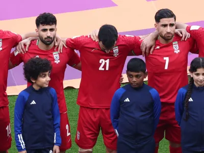 Soccer Football - FIFA World Cup Qatar 2022 - Group B - England v Iran - Khalifa International Stadium, Doha, Qatar - November 21, 2022 Iran's Ahmad Noorollahi, Sadegh Moharrami and Alireza Jahanbakhsh line up during the national anthems before the match REUTERS/Marko Djurica