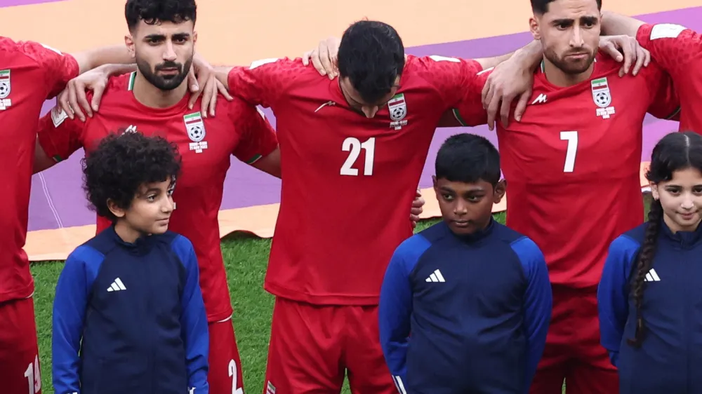 Soccer Football - FIFA World Cup Qatar 2022 - Group B - England v Iran - Khalifa International Stadium, Doha, Qatar - November 21, 2022 Iran's Ahmad Noorollahi, Sadegh Moharrami and Alireza Jahanbakhsh line up during the national anthems before the match REUTERS/Marko Djurica