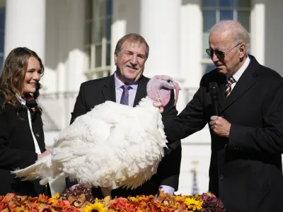 President Joe Biden pardons Chocolate, the national Thanksgiving turkey, at the White House in Washington, Monday, Nov. 21, 2022. Biden is joined by, Ronald Parker, Chairman of the National Turkey Federation, and Alexa Starnes, daughter of the owner of Circle S Ranch. (AP Photo/Andrew Harnik)