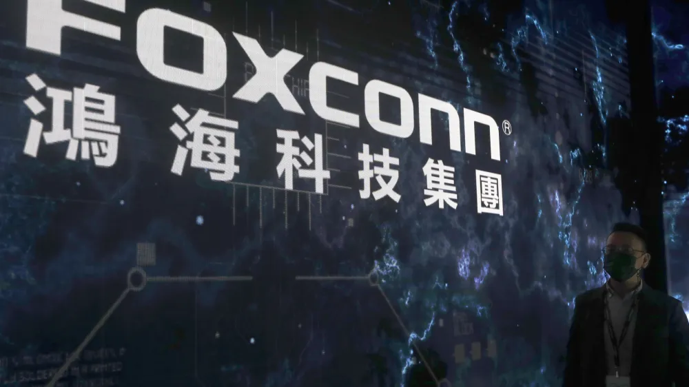 FILE - The Foxconn logo is seen during the Hon Hai Tech Day at the Nangang Exhibition Center in Taipei, Taiwan, on Oct. 18, 2022. Employees at the world's biggest Apple iPhone factory have been beaten and detained in protests over contract disputes amid anti-virus controls, according to employees and videos posted on social media Wednesday, Nov. 23, 2022. Videos that said they were filmed at the factory in the central city of Zhengzhou, China, showed thousands of people in masks facing police in white protective suits with riot shields. (AP Photo/Chiang Ying-ying, File)