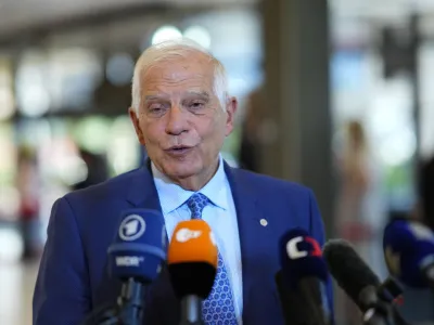 European Union foreign policy chief Josep Borrell speaks with the media as he arrives for a meeting of EU Foreign Ministers at the Prague Congress Center in Prague, Czech Republic, Tuesday, Aug. 30, 2022. (AP Photo/Petr David Josek)