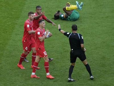 Swiss players complain on handball during the World Cup group G soccer match between Switzerland and Cameroon, at the Al Janoub Stadium in Al Wakrah, Qatar, Thursday, Nov. 24, 2022. (AP Photo/Ebrahim Noroozi)