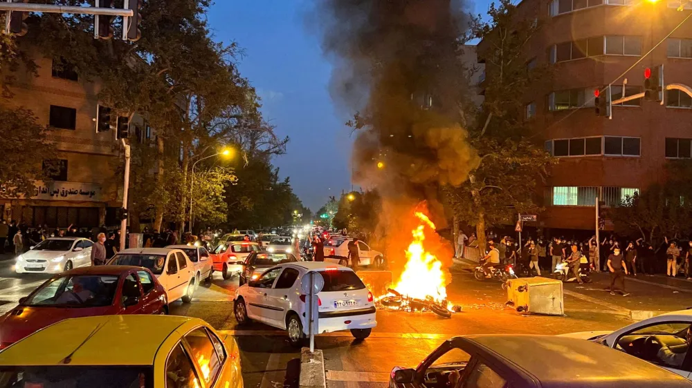 FILE PHOTO: A police motorcycle burns during a protest over the death of Mahsa Amini, a woman who died after being arrested by the Islamic republic's "morality police", in Tehran, Iran September 19, 2022. WANA (West Asia News Agency) via REUTERS/File Photo