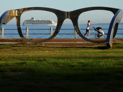 A lady runs with a pram along the Sea Point Promenade as The World, an exclusive private residential ship during its 2024 journey to six continents, arrives in Cape Town, South Africa, February 28, 2024. REUTERS/Esa Alexander   TPX IMAGES OF THE DAY