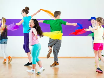 E8N634 Children dancing modern group choreography with scarfs