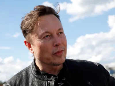 FILE PHOTO: Tesla CEO Elon Musk looks on as he visits the construction site of Tesla's gigafactory in Gruenheide, near Berlin, Germany, May 17, 2021. REUTERS/Michele Tantussi/File Photo