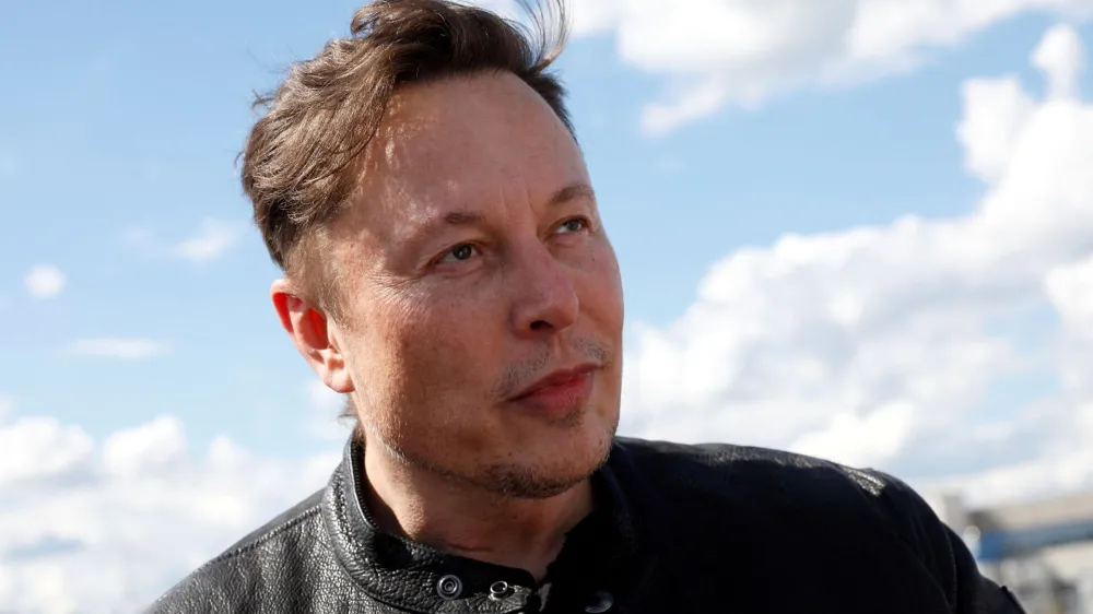 FILE PHOTO: Tesla CEO Elon Musk looks on as he visits the construction site of Tesla's gigafactory in Gruenheide, near Berlin, Germany, May 17, 2021. REUTERS/Michele Tantussi/File Photo