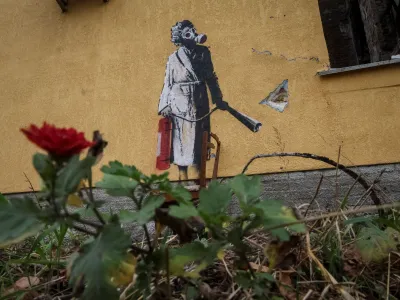 A new graffiti in Banksy's signature style, although not posted by the mercurial artist on social media, is seen on the wall of a destroyed building in the Ukrainian town of Hostomel, which had been occupied by Russia until April and heavily damaged by fighting in the early days of Russian invasion, November 13, 2022. REUTERS/Gleb Garanich