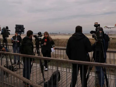 Journalists gather after a commercial airplane flying from Morocco to Turkey made an emergency landing in Barcelona's El Prat airport in the early hours and 28 would-be migrants on board ran away across the tarmac in Barcelona, Spain December 7, 2022. REUTERS/Nacho Doce