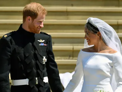 FILE - Prince Harry and Meghan Markle walk down the steps after their wedding at St. George's Chapel in Windsor Castle in Windsor, near London, England, Saturday, May 19, 2018. Britain's monarchy is bracing for more bombshells to be lobbed over the palace gates Thursday, Dec. 8, 2022 as Netflix releases the first three episodes of a series that promises to tell the "full truth" about Prince Harry and Meghan's estrangement from the royal family. (Ben Birchhall/pool photo via AP, file)