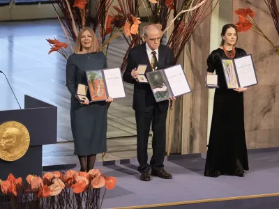 Representatives of the 2022 Nobel Peace Prize laureates, from left: Natalia Pinchuk, the wife of Nobel Peace Prize winner Ales Bialiatski, Yan Rachinsky, chairman of the International Memorial Board and Oleksandra Matviychuk, head of the Ukraine's Center for Civil Liberties pose with awards during the Nobel Peace Prize ceremony at Oslo City Hall, Norway, Saturday, Dec. 10, 2022. The winners of this year's Nobel Peace Prize from Ukraine, Russia and Belarus have shared their visions of a fairer world during an award ceremony and denounced Russian President Vladimir Putin's war in Ukraine. (AP Photo/ Markus Schreiber)