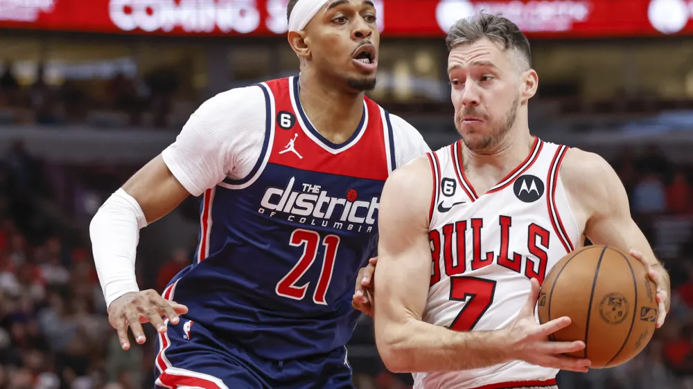 Dec 7, 2022; Chicago, Illinois, USA; Chicago Bulls guard Goran Dragic (7) drives to the basket against Washington Wizards center Daniel Gafford (21) during the second half at United Center. Mandatory Credit: Kamil Krzaczynski-USA TODAY Sports